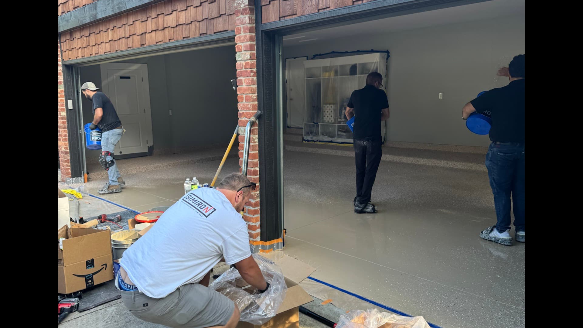 Reserve Coatings four-person installation crew on a residential garage project